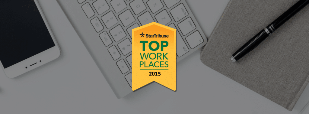 workspace flatlay with 2015 Star Tribune Top Workplaces Banner