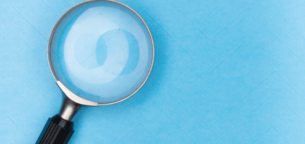 magnifying glass on light blue background