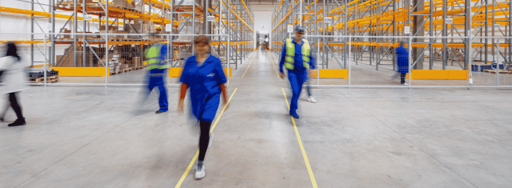 employees walking around a warehouse environment