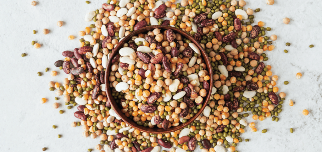 variety of seeds and beans on a white table