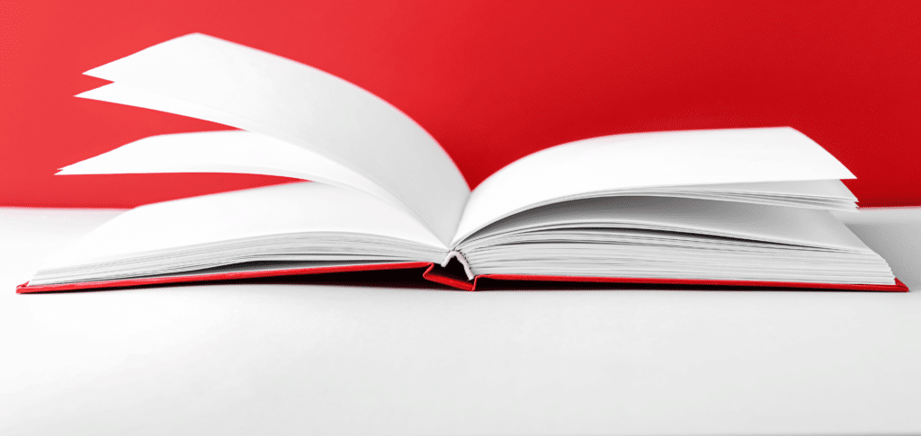 open book on a table with a red background