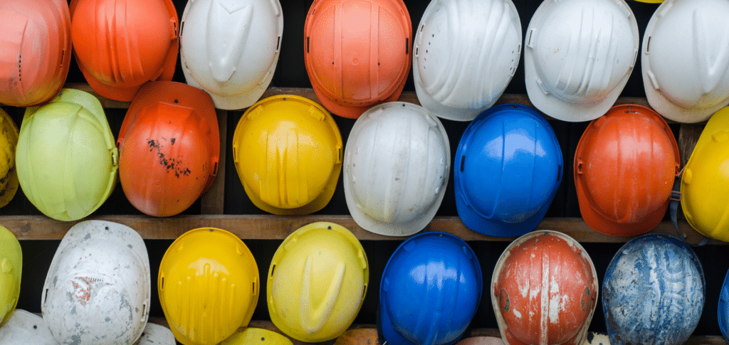 wall of multiple colors of hard hats