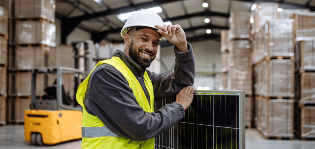 manufacturing worker in warehouse smiling
