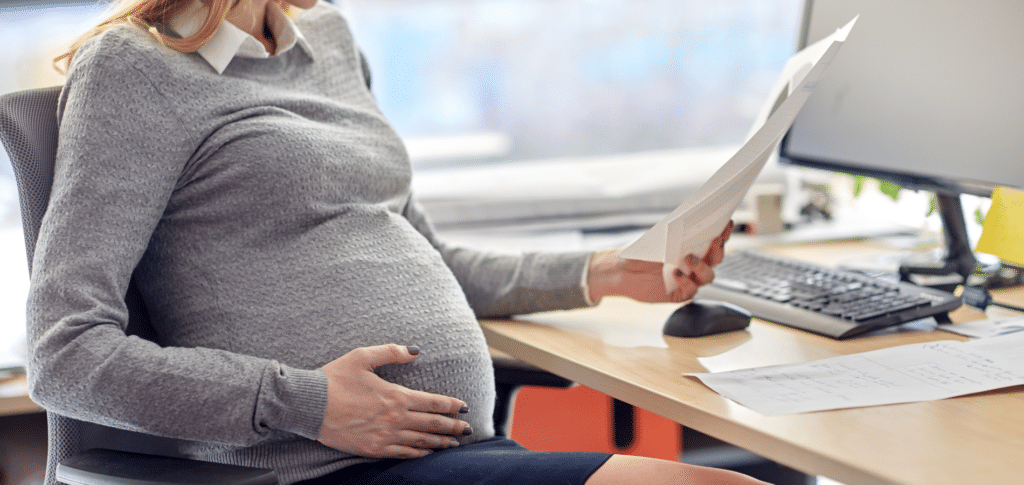 Pregnant woman sitting at desk working